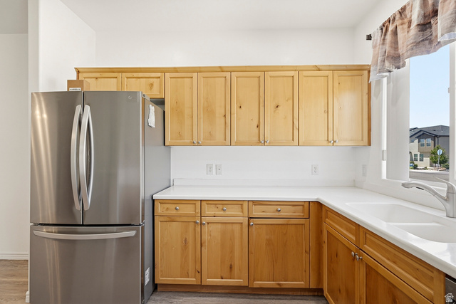 1177 Northfield Road, Unit 26 Cedar City, UT 84721 - Photo 13 of 45 Kitchen featuring light wood cabinetry, white countertops, stainless steel French door refrigerator, and an undermount sink with a gooseneck faucet