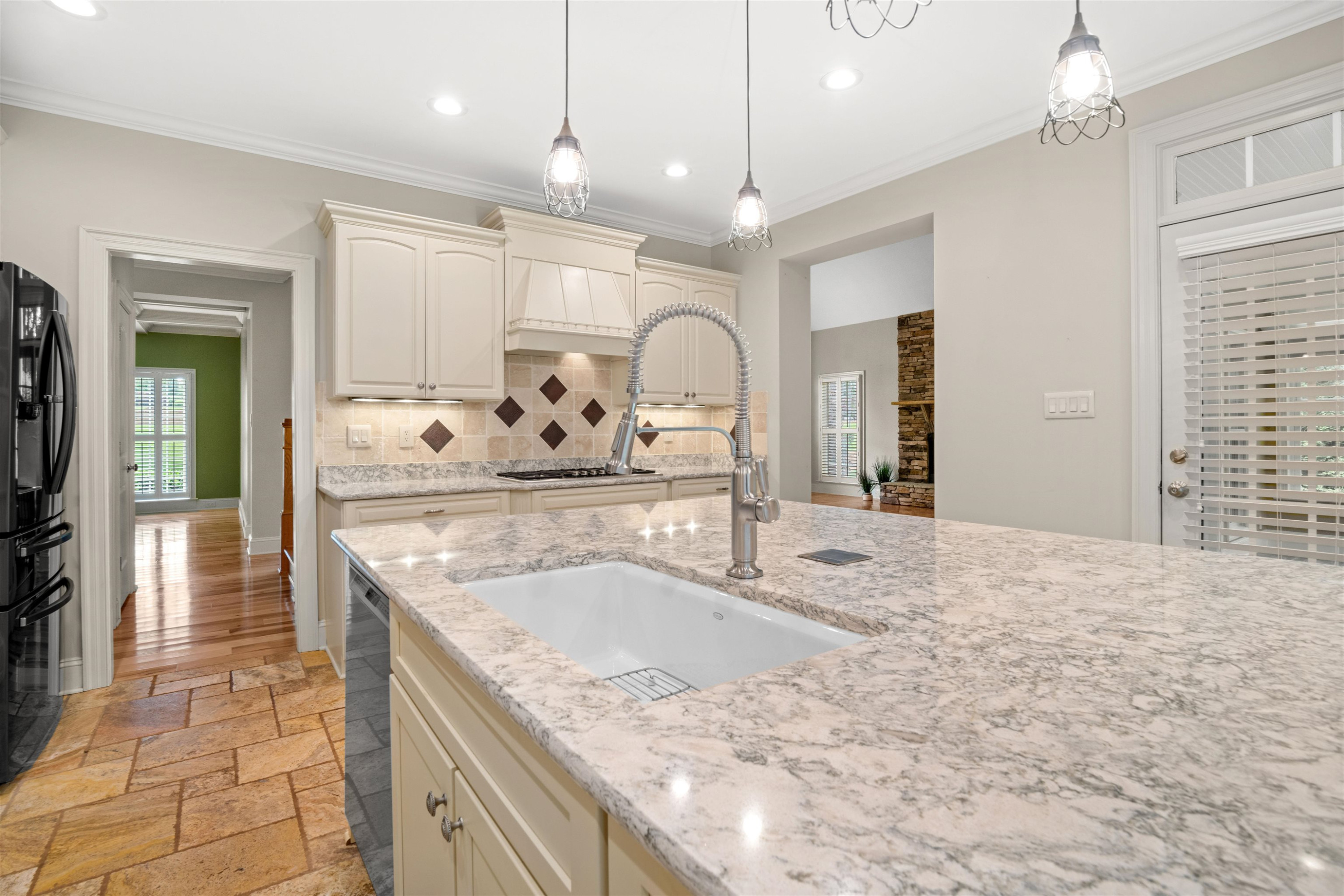 20 Jackson Road Youngsville, NC 27596 - Photo 16 of 41 a large kitchen with kitchen island a sink granite counter tops and a view of living room
