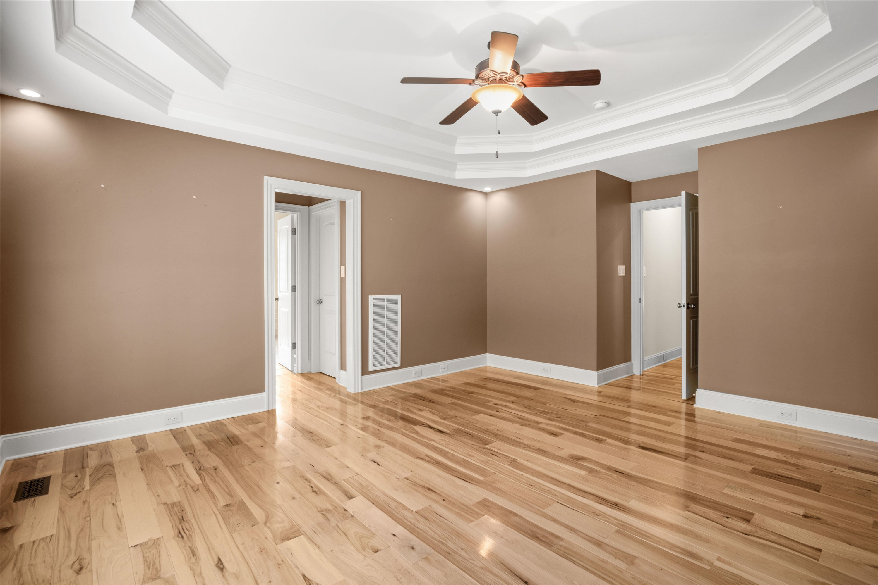 20 Jackson Road Youngsville, NC 27596 - Photo 21 of 41 a view of an empty room with wooden floor and a ceiling fan