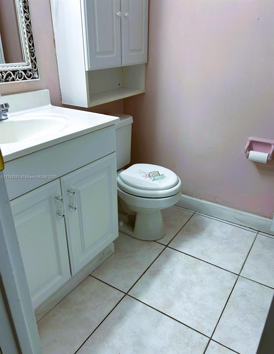 942 Northeast 199th Street, Unit 3E Miami, FL 33179 - Photo 18 of 31 a bathroom with a toilet and a sink