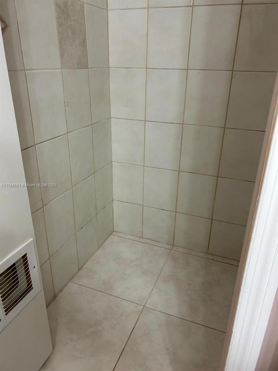 942 Northeast 199th Street, Unit 3E Miami, FL 33179 - Photo 19 of 31 a bathroom with a shower