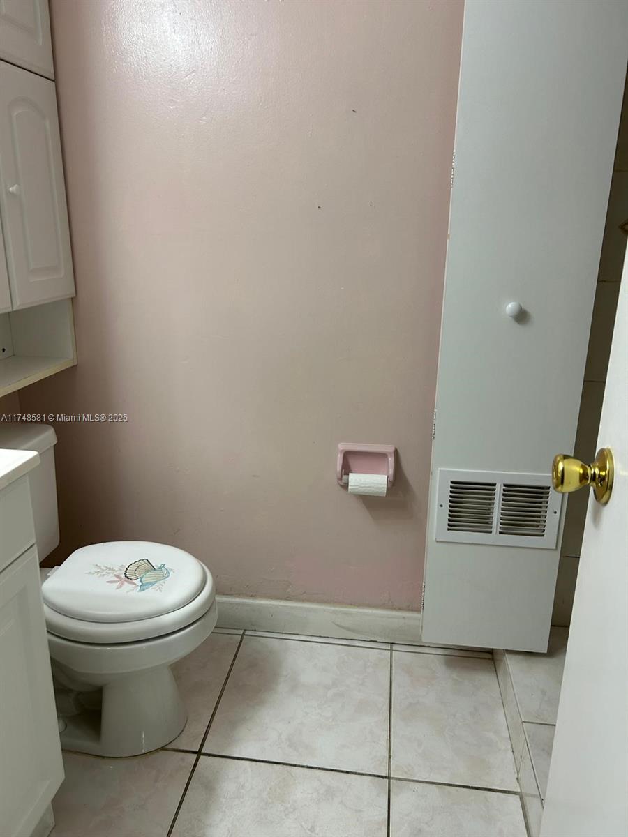 942 Northeast 199th Street, Unit 3E Miami, FL 33179 - Photo 20 of 31 a white toilet sitting next to a white sink