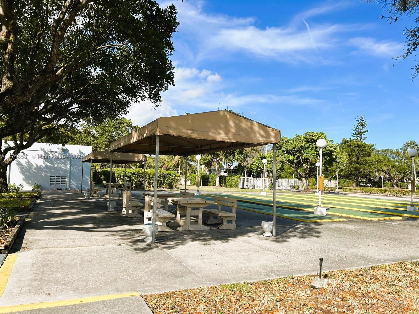 942 Northeast 199th Street, Unit 3E Miami, FL 33179 - Photo 31 of 31 an outdoor space with pool and furniture