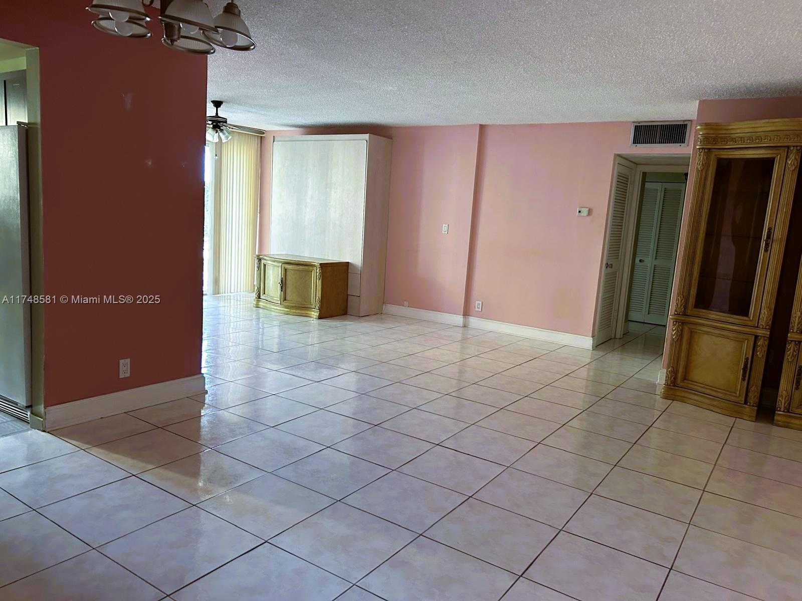 942 Northeast 199th Street, Unit 3E Miami, FL 33179 - Photo 6 of 31 an empty room with wooden floor