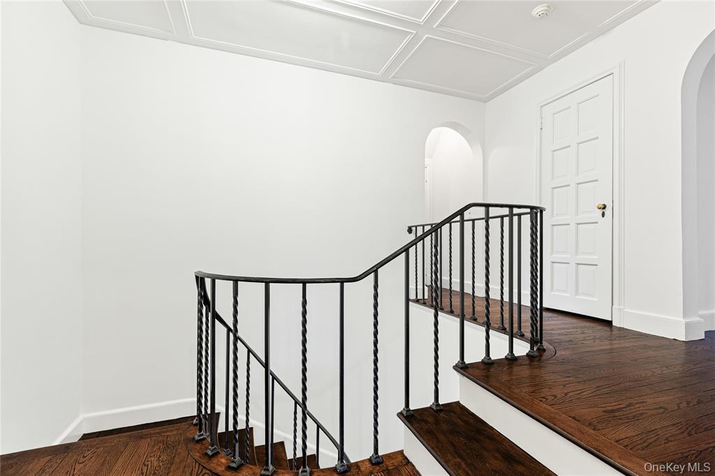 6 Fox Meadow Road Scarsdale, NY 10583 - Photo 9 of 20 Stairs with arched walkways, wood finished floors, and baseboards