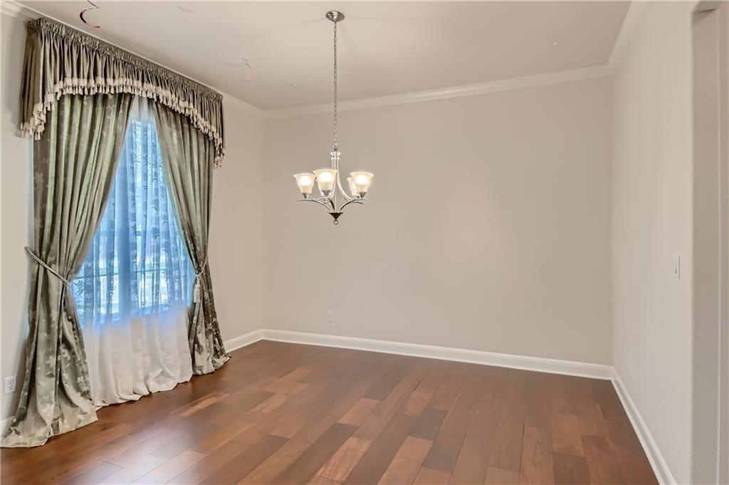 3822 Remington Road Cedar Park, TX 78613 - Photo 7 of 31 an empty room with wooden floor and windows