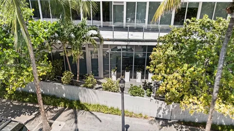 a living room with furniture a large window and a table