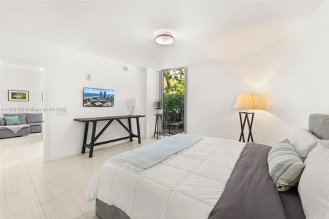 a bedroom with a bed and a lamp on table