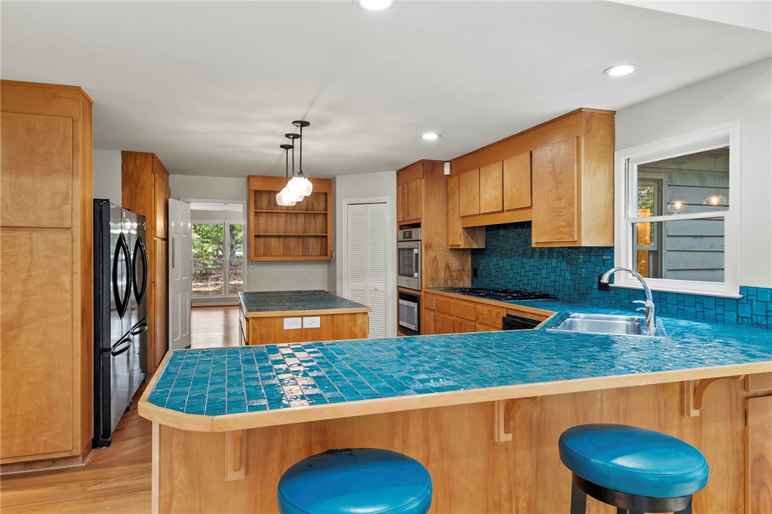 225 Arrowhead Trail Easley, SC 29642 - Photo 8 of 33 This spacious kitchen offers ample storage and a unique, vibrant countertop design.