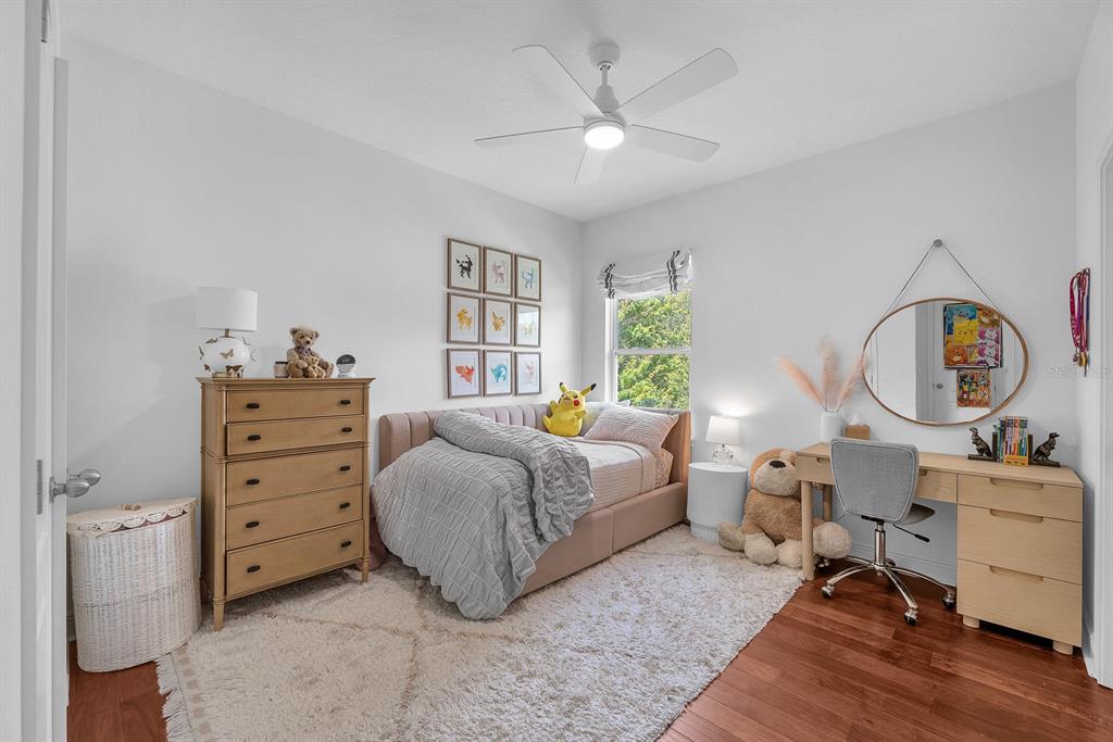 5310 Fishhawk Ridge Drive Lithia, FL 33547 - Photo 34 of 52 a bedroom with a bed and a chandelier