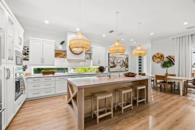 a kitchen with stainless steel appliances kitchen island granite countertop a sink and dishwasher a stove with wooden floor