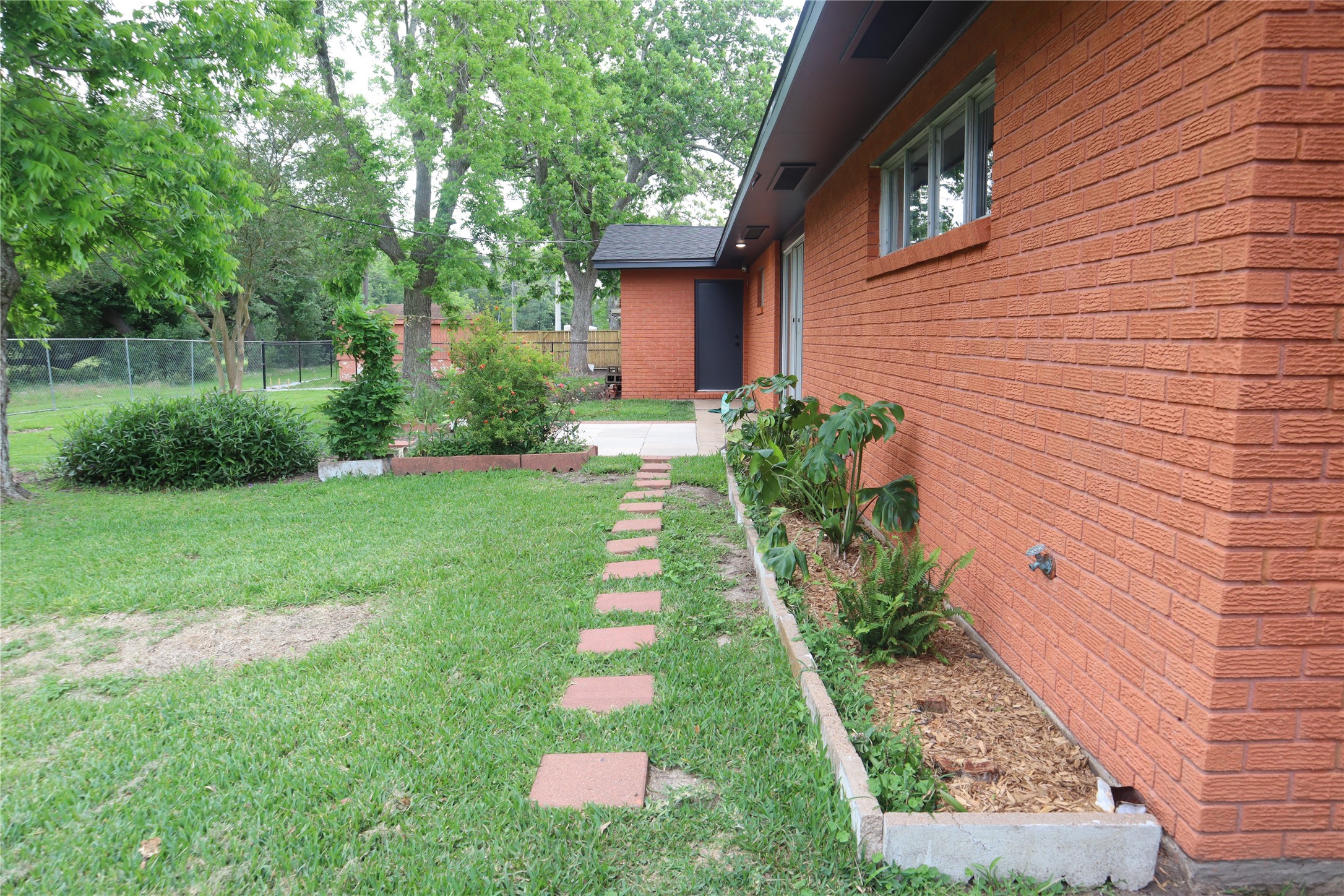 1903 Evergreen La Marque, TX 77568 - Photo 32 of 33 a front view of a house with a yard and potted plants