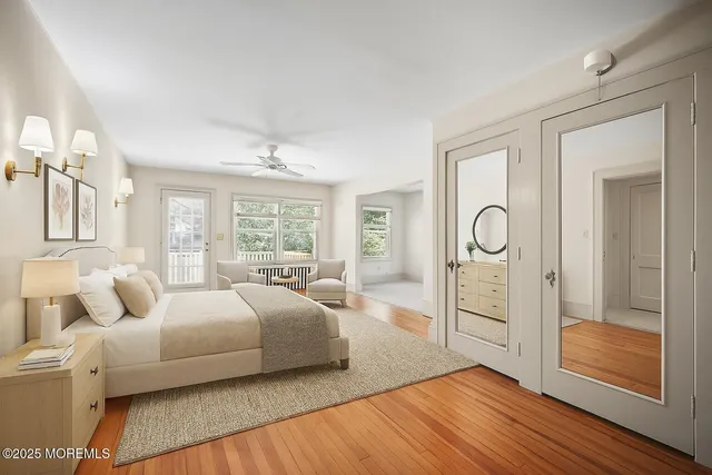 a large bedroom with a bed and wooden floor