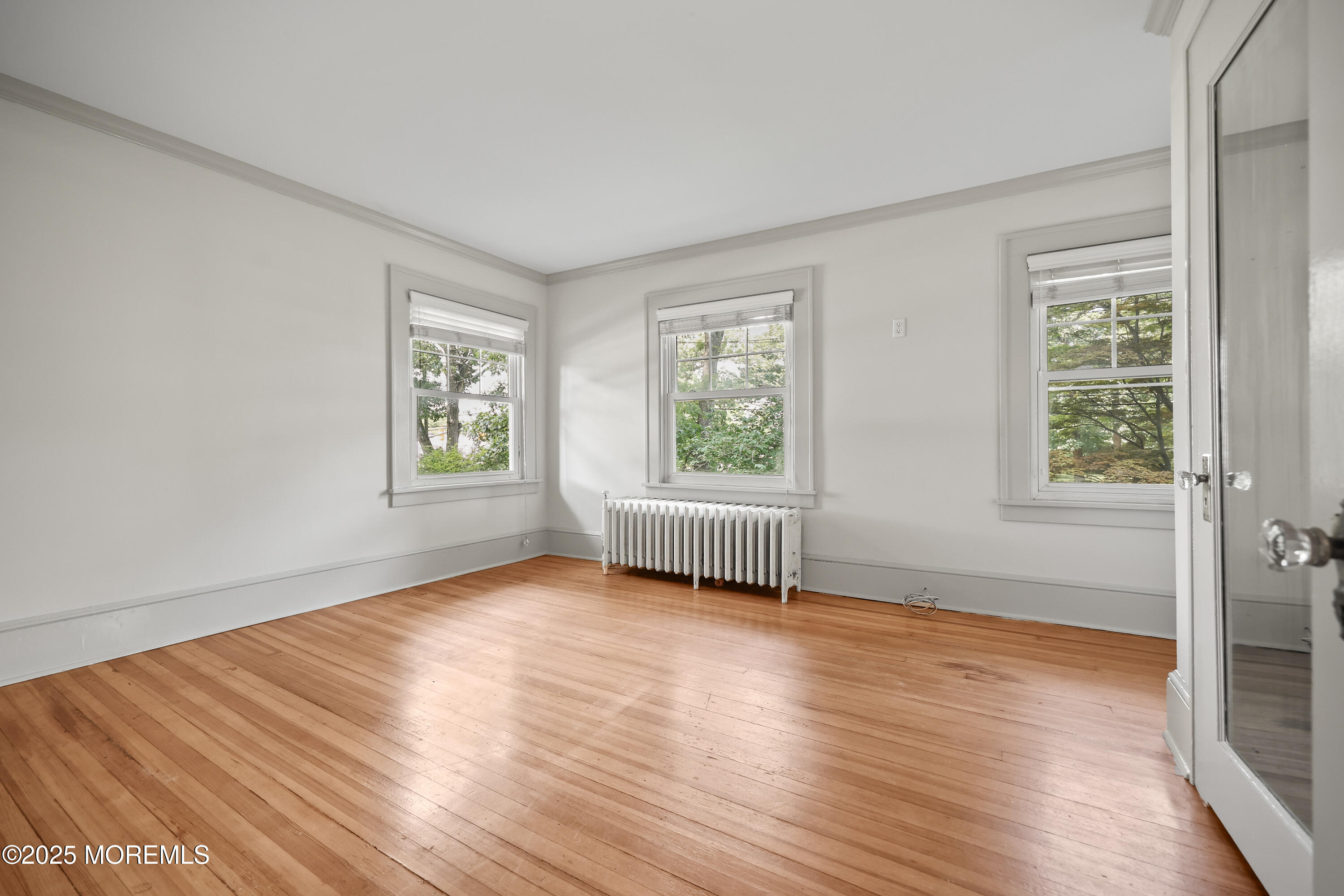 3 River Road Rumson, NJ 07760 - Photo 8 of 22 an empty room with wooden floor and windows