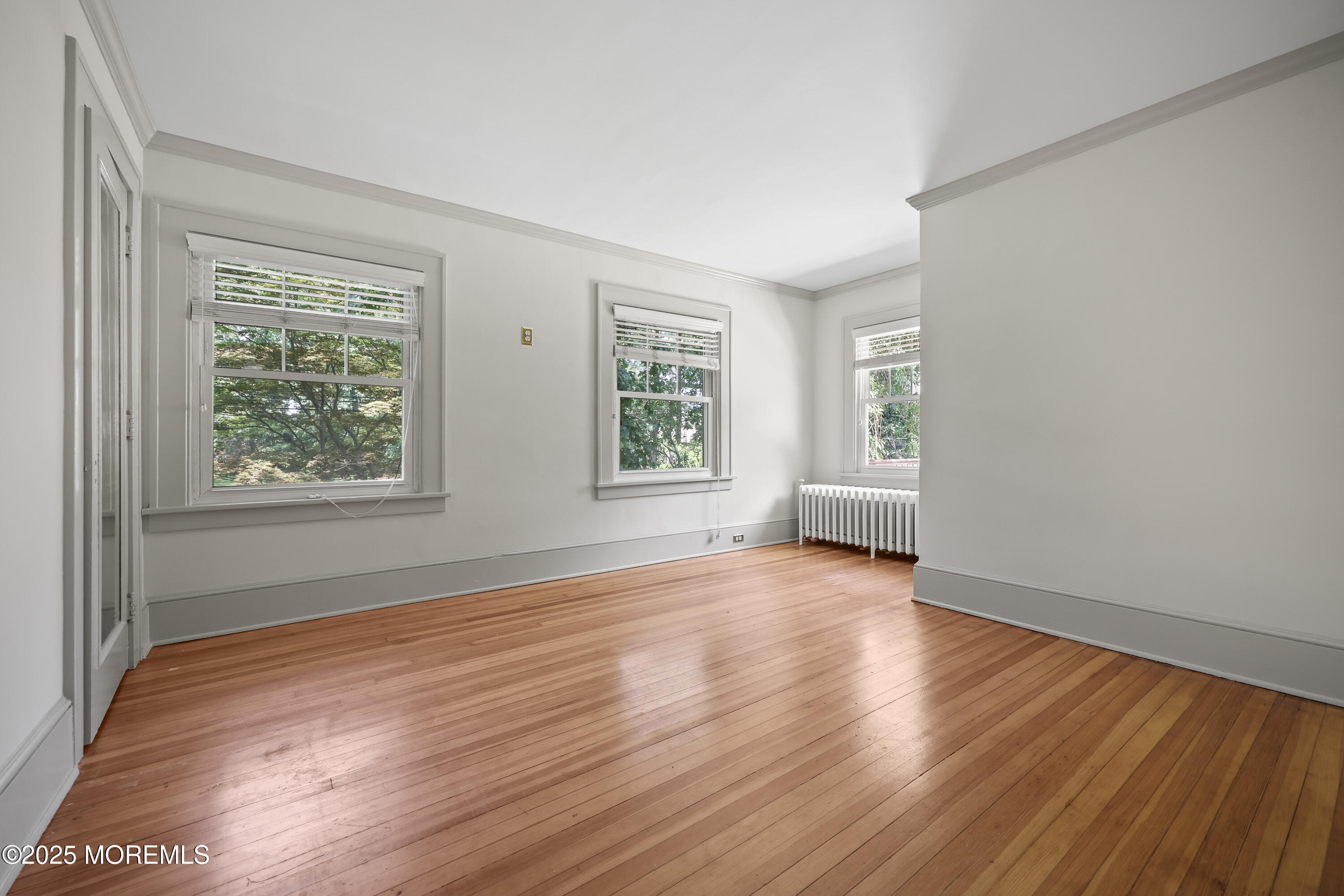 3 River Road Rumson, NJ 07760 - Photo 10 of 22 an empty room with wooden floor and windows