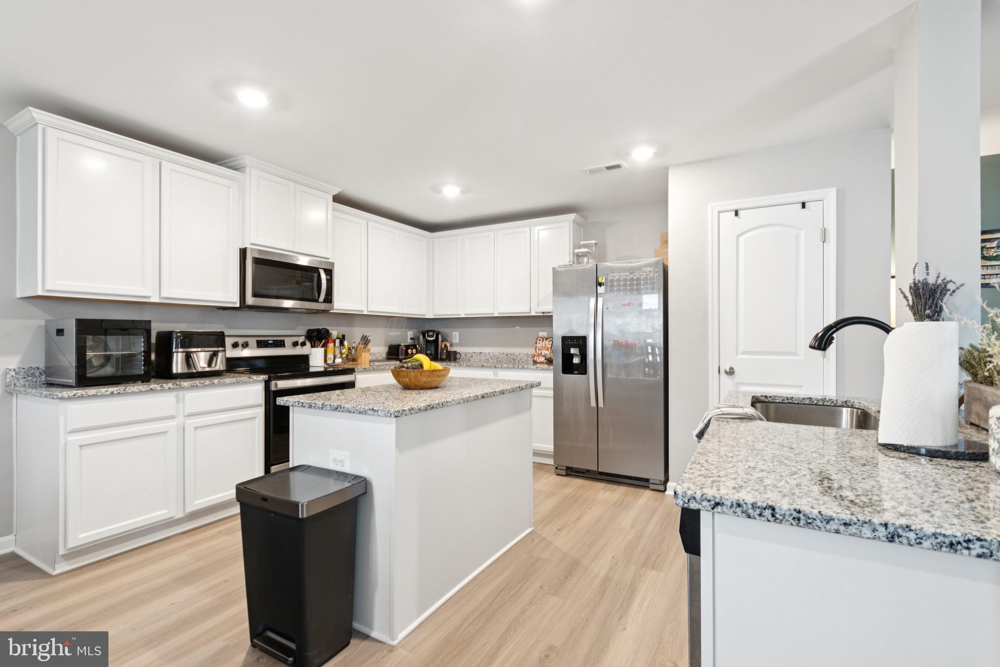 17063 Rollins Road Bowling Green, VA 22427 - Photo 12 of 40 a kitchen with stainless steel appliances granite countertop a refrigerator a stove top oven a sink and dishwasher