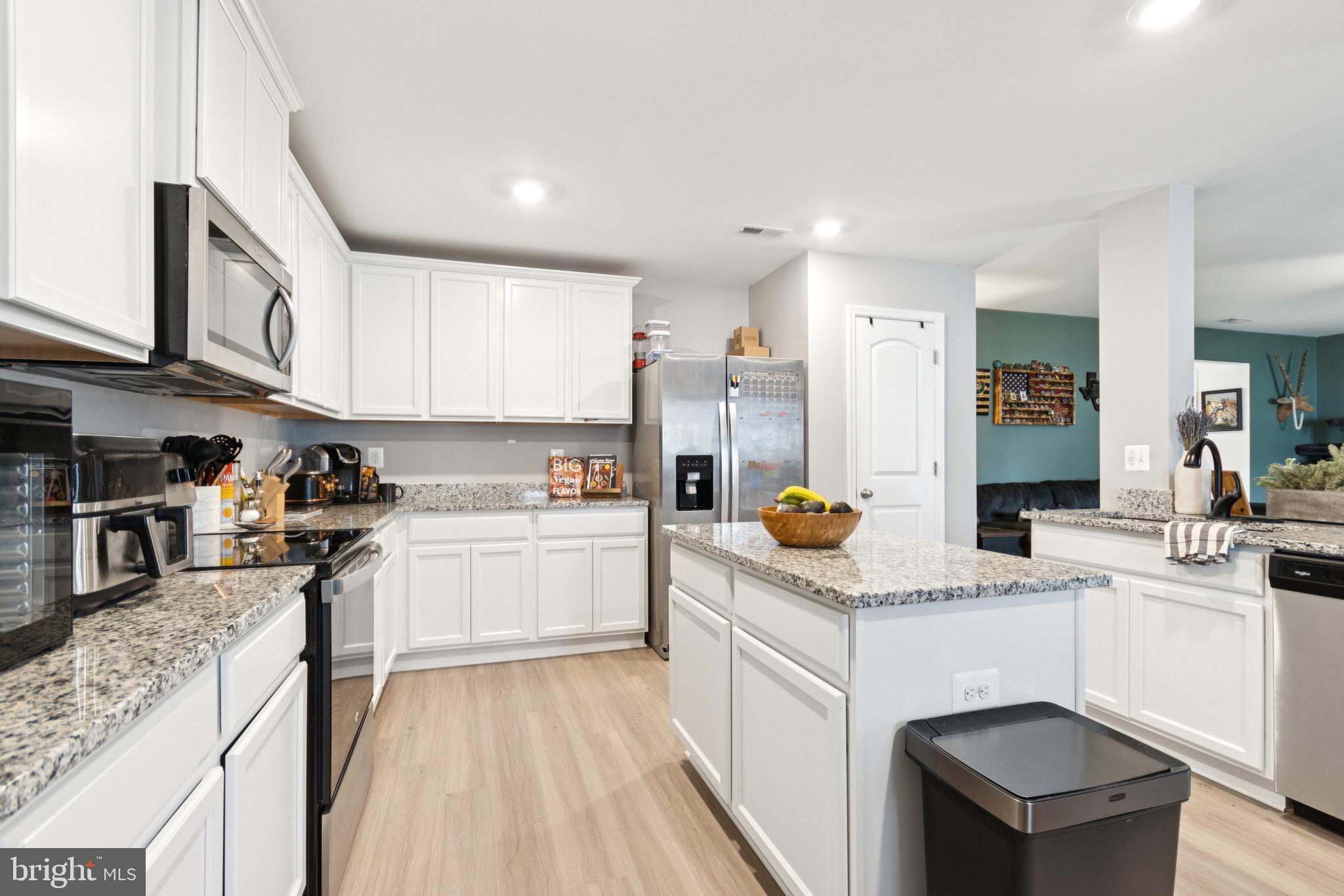 17063 Rollins Road Bowling Green, VA 22427 - Photo 13 of 40 a kitchen with a sink white cabinets and stainless steel appliances