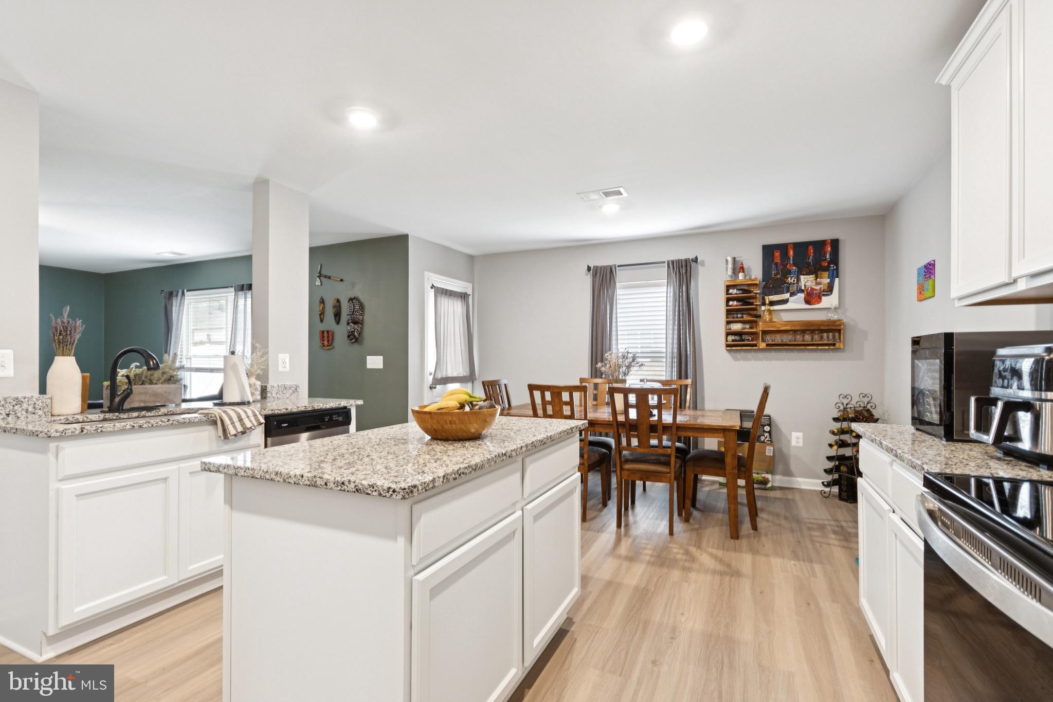 17063 Rollins Road Bowling Green, VA 22427 - Photo 14 of 40 a view of a kitchen area with furniture and wooden floor