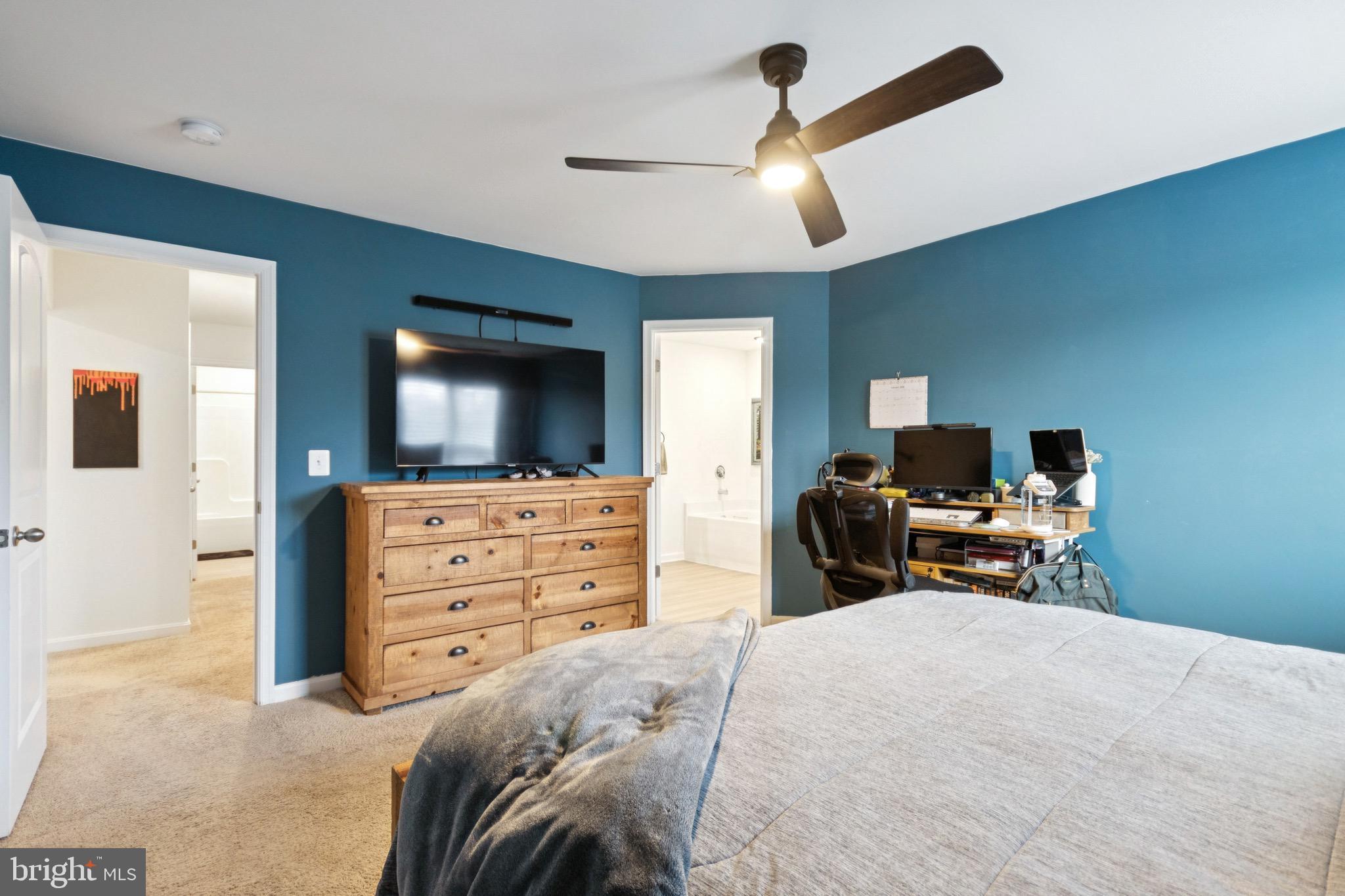 17063 Rollins Road Bowling Green, VA 22427 - Photo 22 of 40 a bedroom with a bed and a flat tv screen on dresser