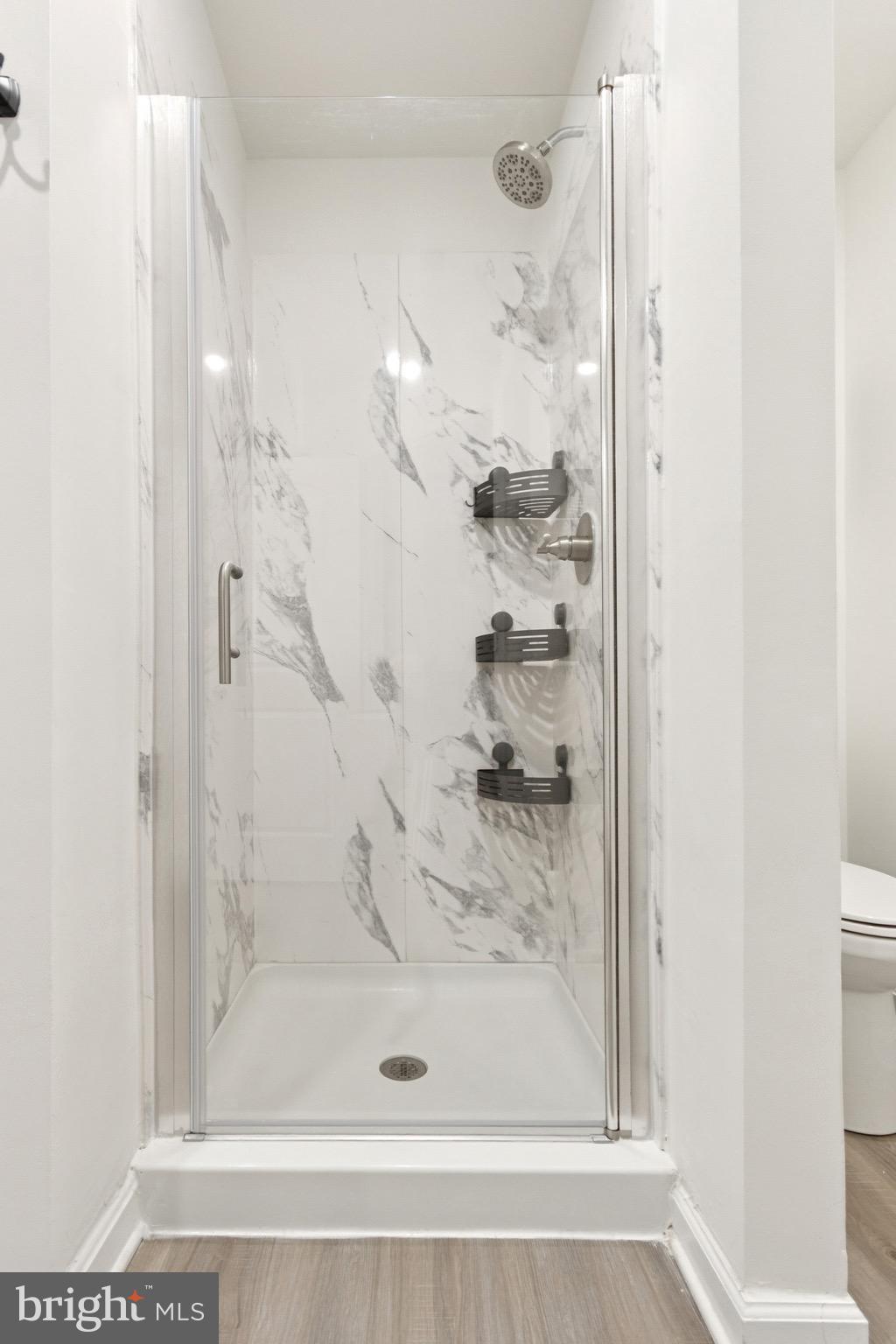 17063 Rollins Road Bowling Green, VA 22427 - Photo 26 of 40 a bathroom with a glass shower door