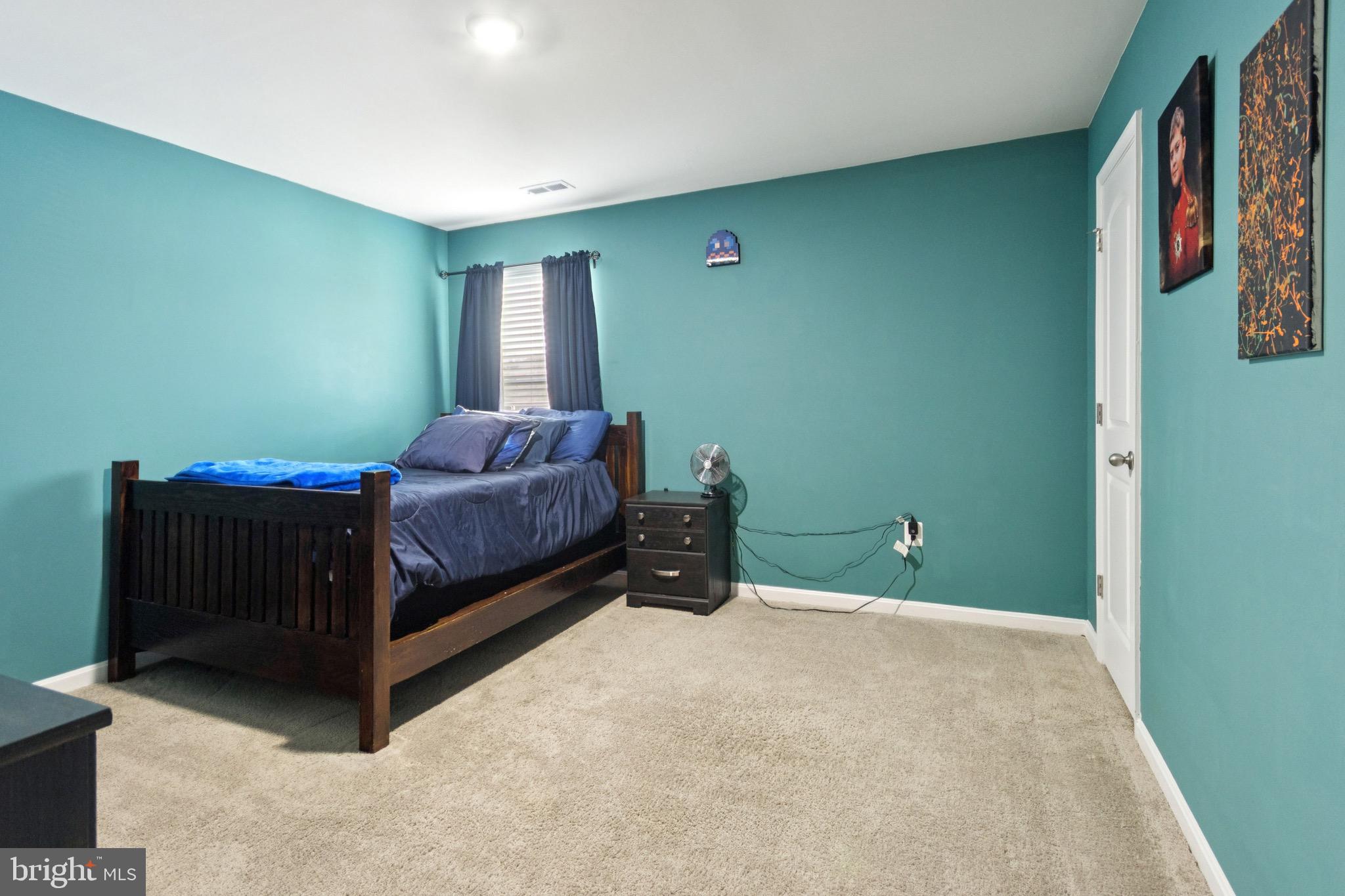 17063 Rollins Road Bowling Green, VA 22427 - Photo 28 of 40 a bedroom with a bed and a window