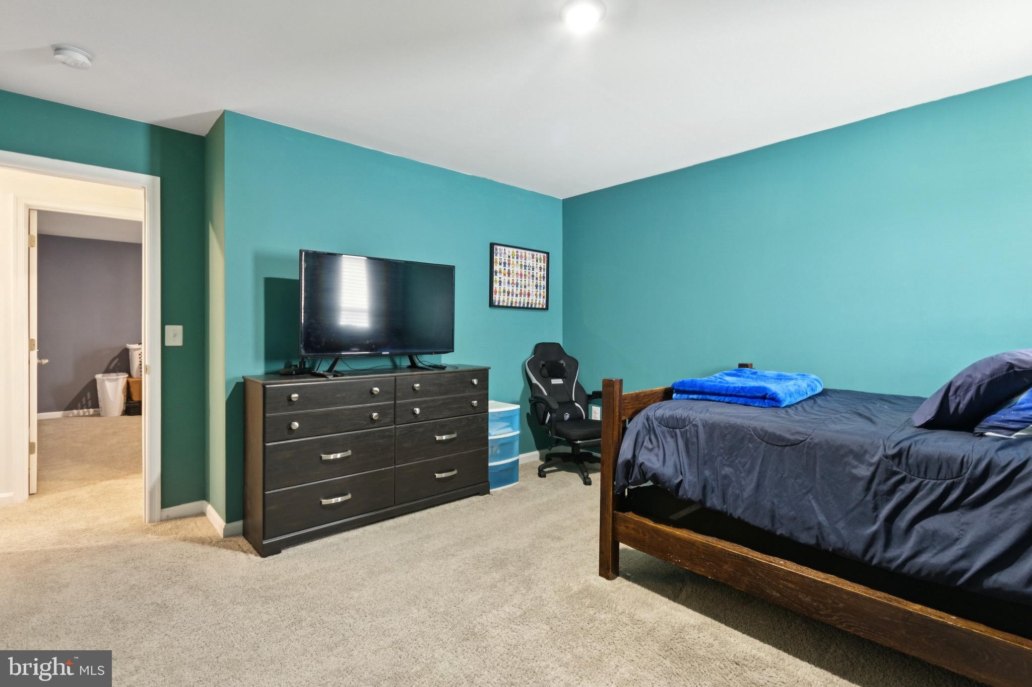 17063 Rollins Road Bowling Green, VA 22427 - Photo 29 of 40 a bedroom with a bed and a flat screen tv