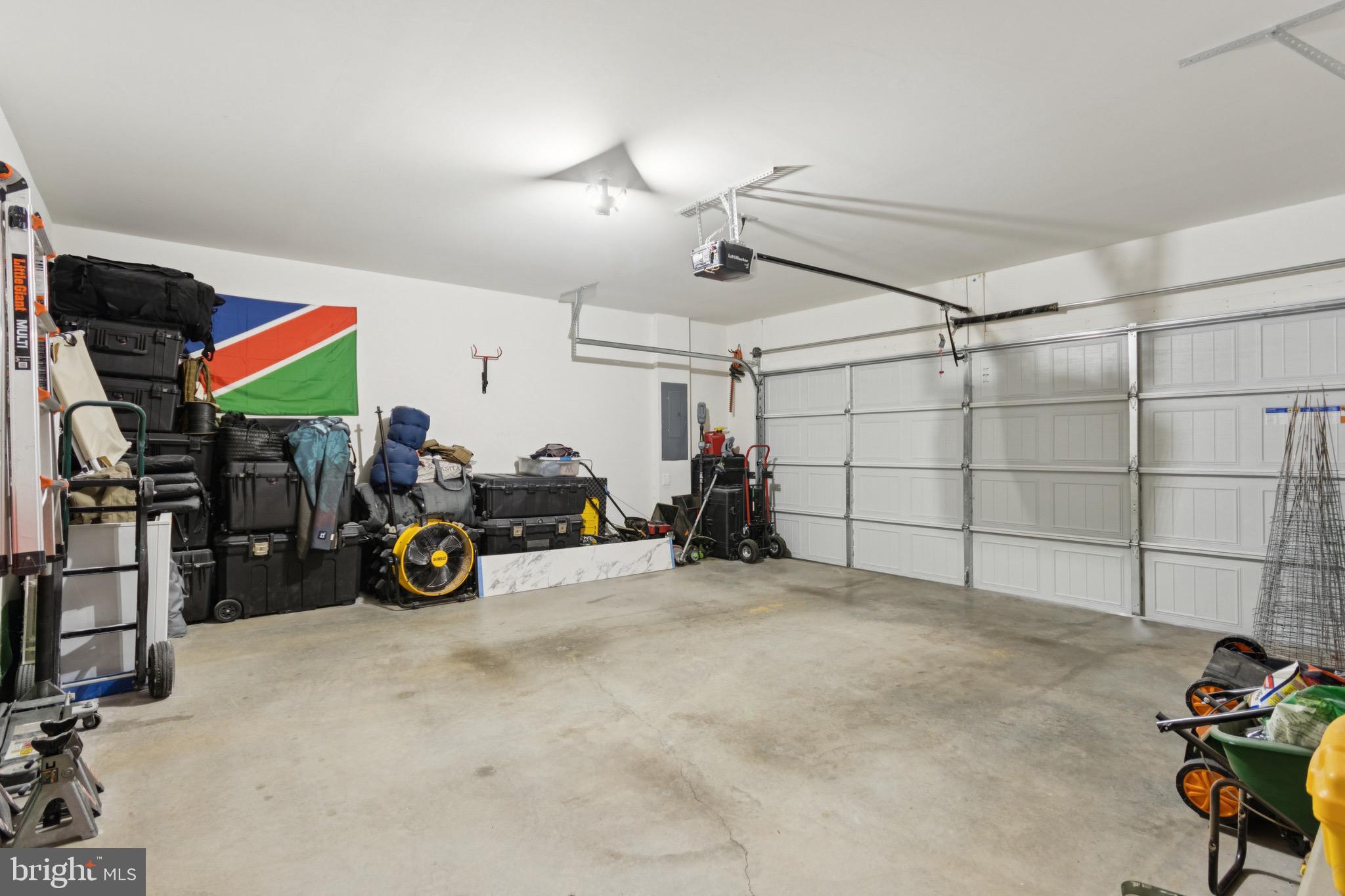 17063 Rollins Road Bowling Green, VA 22427 - Photo 35 of 40 a view of a garage with a bike and white house