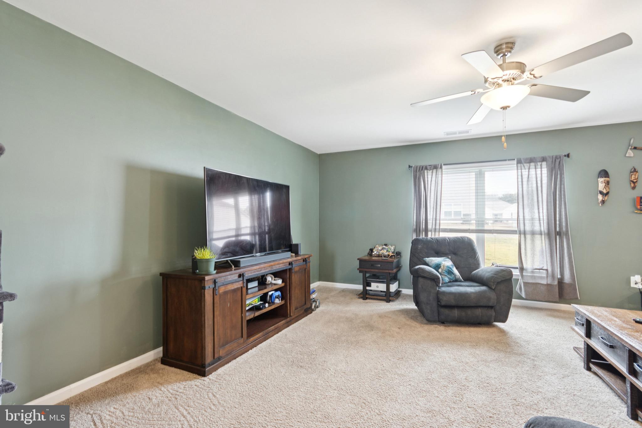 17063 Rollins Road Bowling Green, VA 22427 - Photo 9 of 40 a living room with furniture and a flat screen tv