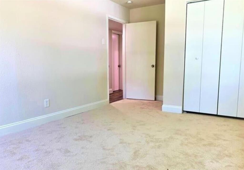 2536 Rutherford Street Irving, TX 75062 - Photo 11 of 19 Neutral-toned carpeting paired with light-colored walls and white baseboards