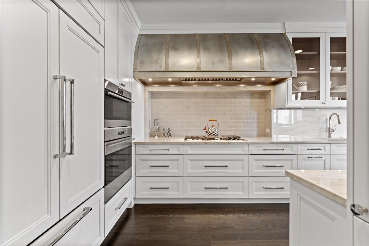 10 East Delaware Place, Unit 28E Chicago, IL 60611 - Photo 12 of 41 a kitchen with granite countertop white cabinets and stainless steel appliances