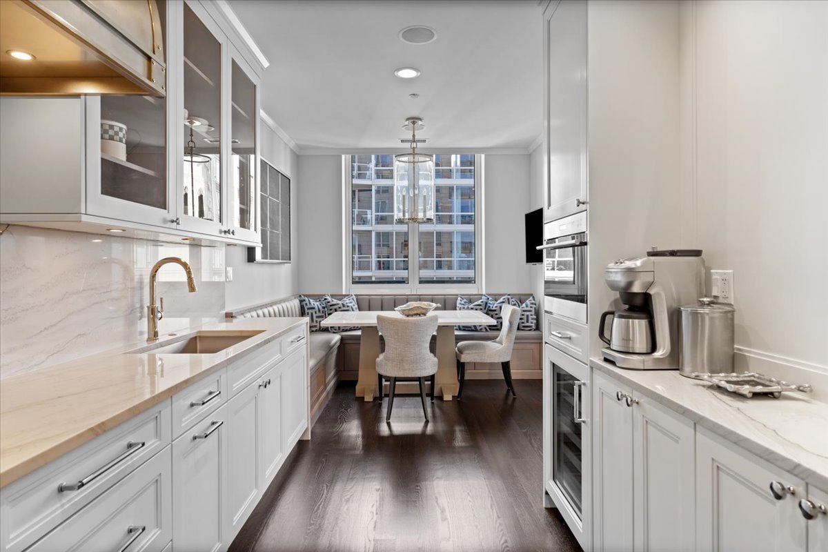 10 East Delaware Place, Unit 28E Chicago, IL 60611 - Photo 13 of 41 a kitchen with lots of appliances and cabinets