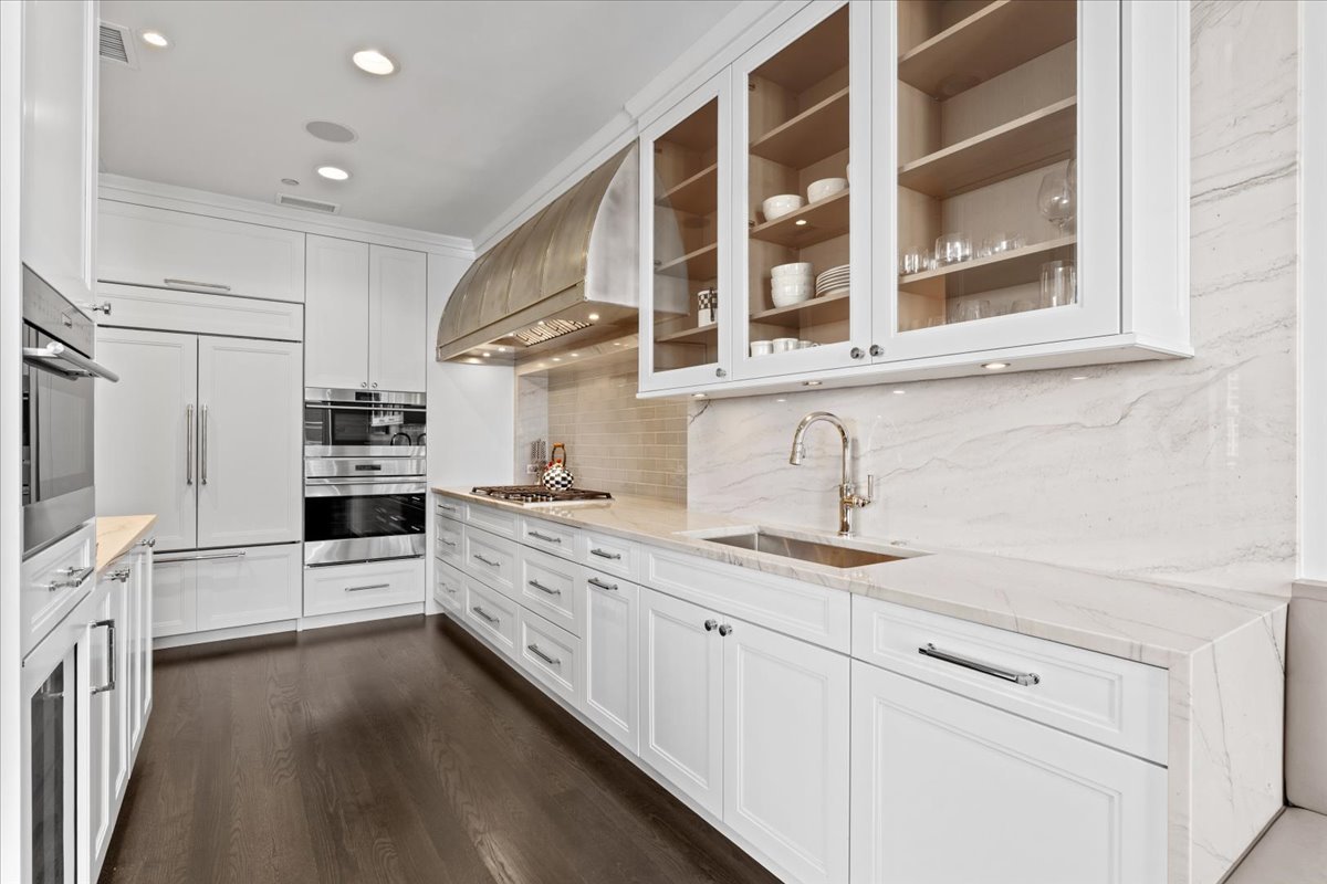 10 East Delaware Place, Unit 28E Chicago, IL 60611 - Photo 14 of 41 a kitchen with stainless steel appliances white cabinets and a sink