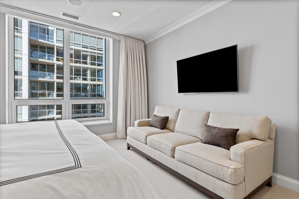 10 East Delaware Place, Unit 28E Chicago, IL 60611 - Photo 20 of 41 a living room with furniture and a flat screen tv