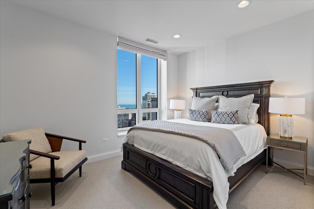 10 East Delaware Place, Unit 28E Chicago, IL 60611 - Photo 24 of 41 a bed sitting in a bedroom next to a window