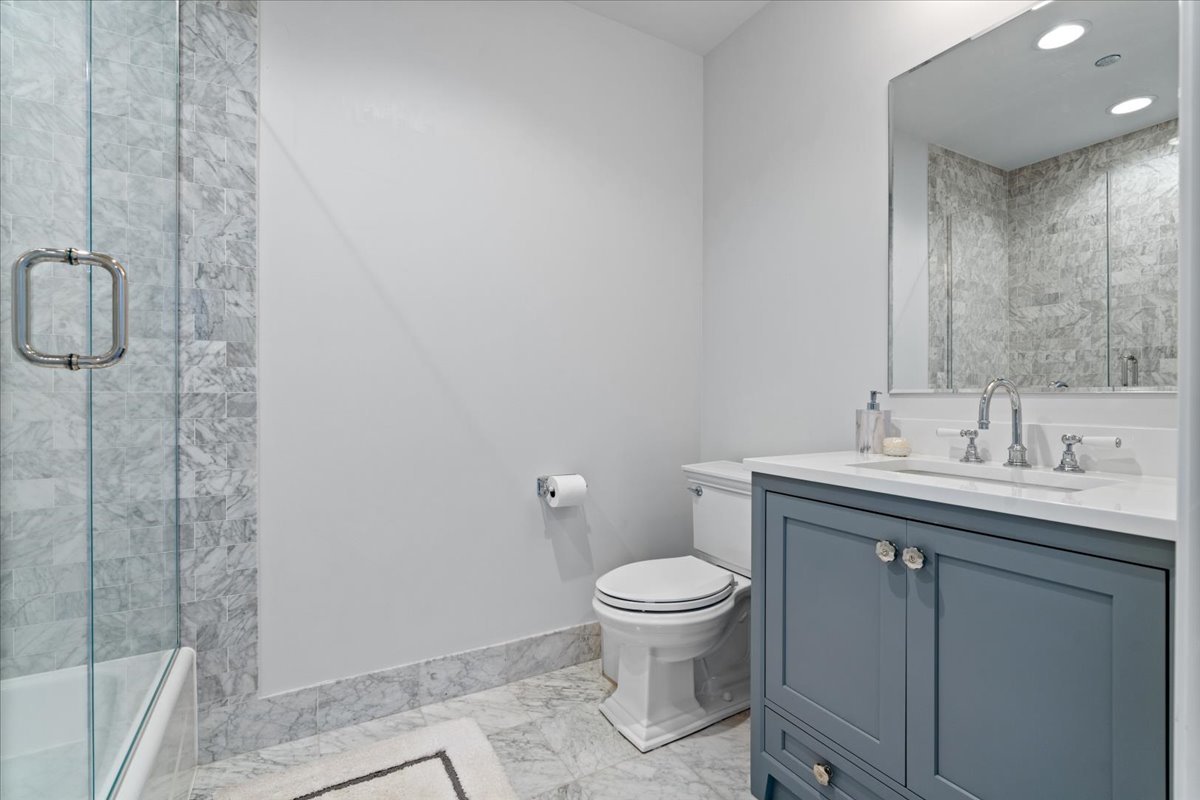 10 East Delaware Place, Unit 28E Chicago, IL 60611 - Photo 26 of 41 a bathroom with a sink a toilet and shower