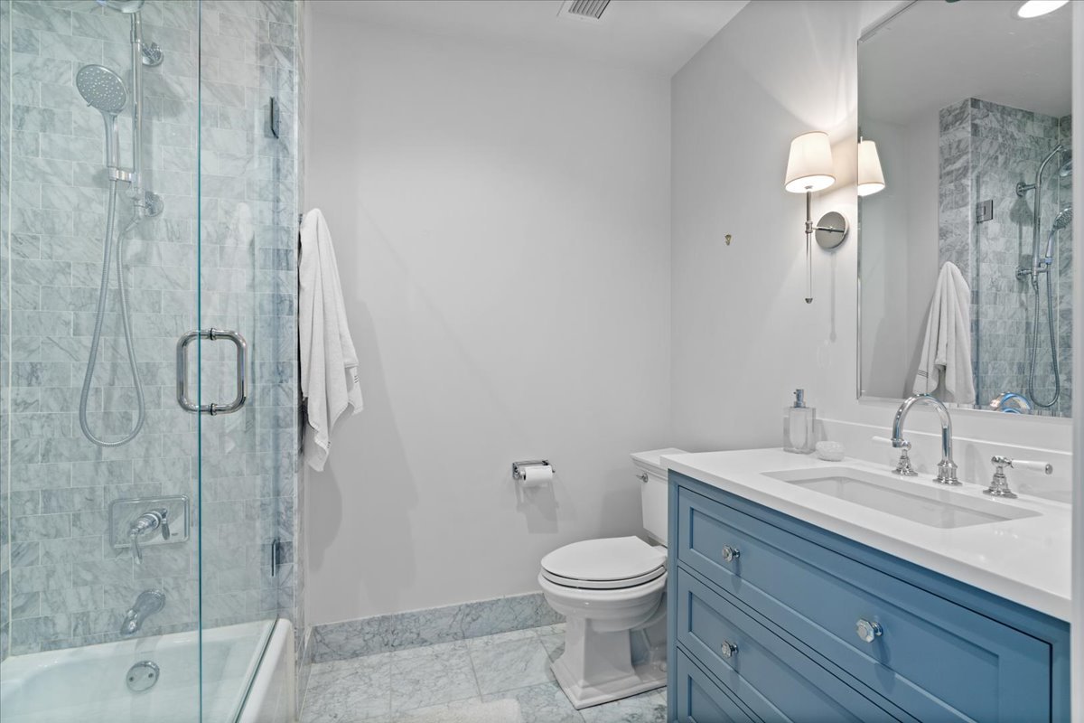 10 East Delaware Place, Unit 28E Chicago, IL 60611 - Photo 29 of 41 a bathroom with a toilet a sink and shower