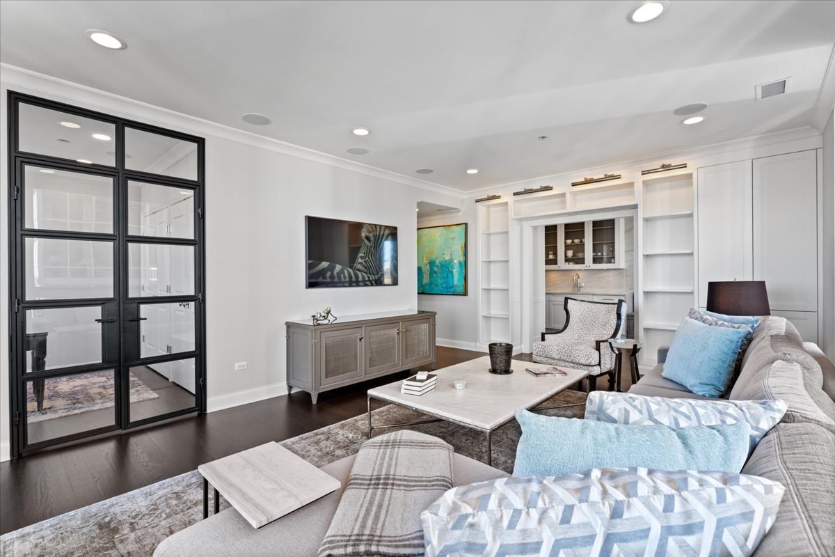 10 East Delaware Place, Unit 28E Chicago, IL 60611 - Photo 10 of 41 a living room with furniture wooden floor and a flat screen tv