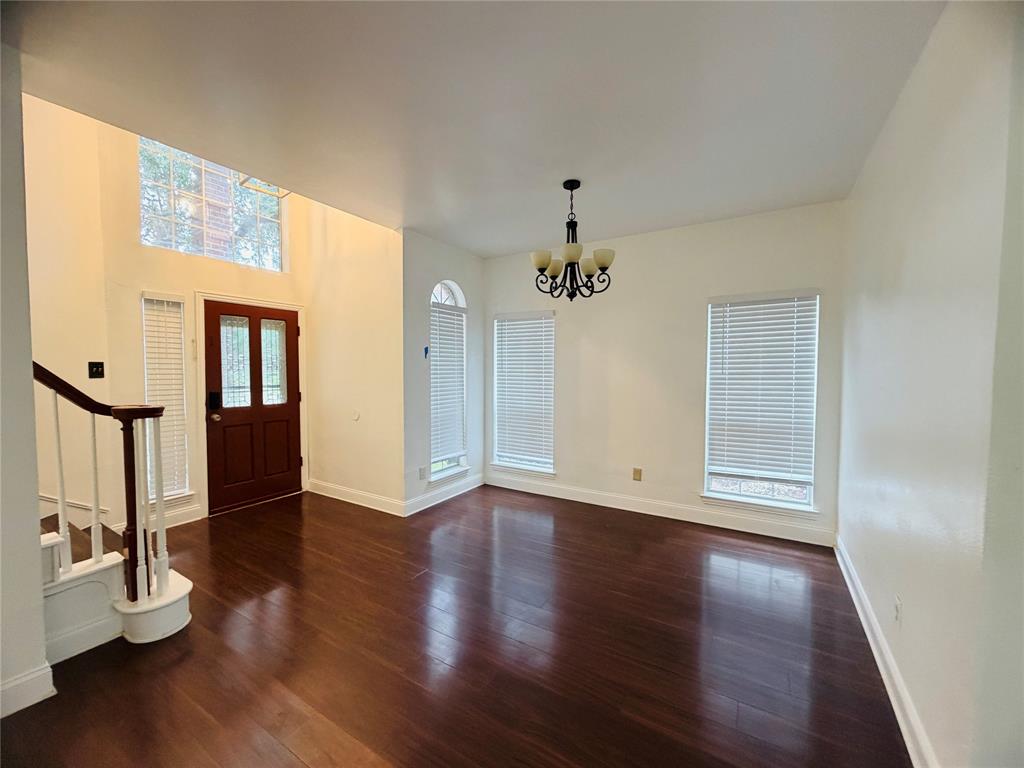 434 Moonlight Way Irving, TX 75063 - Photo 6 of 29 a view of an empty room with wooden floor and a window