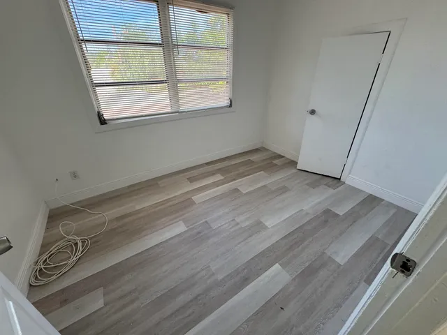 an empty room with wooden floor