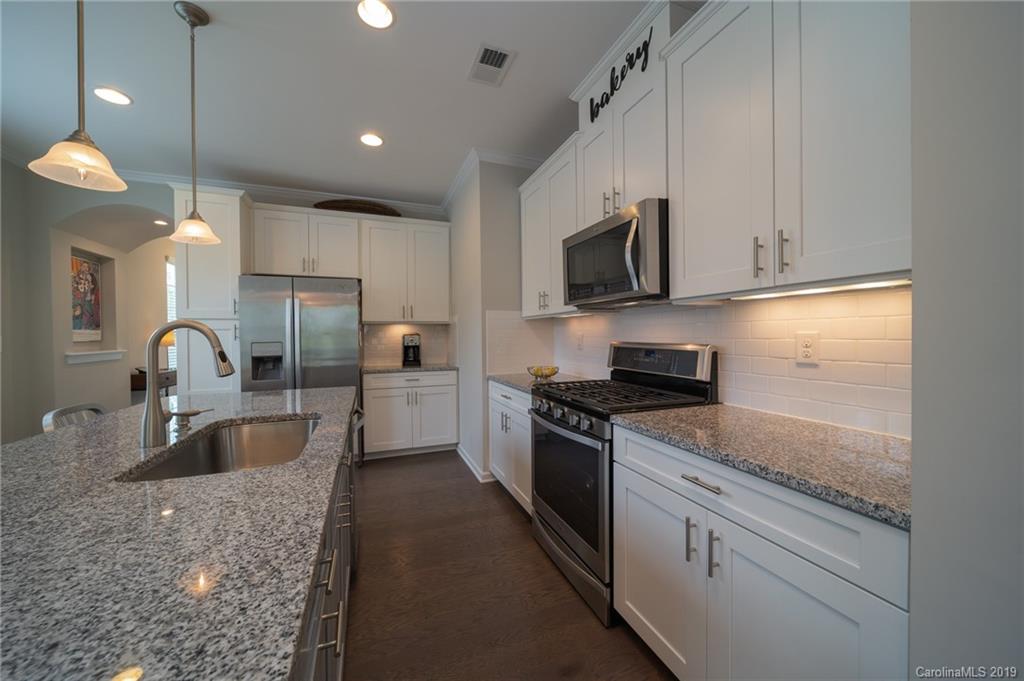 1002 Archibald Avenue Fort Mill, SC 29708 - Photo 11 of 26 a kitchen with stainless steel appliances granite countertop a sink a stove and a refrigerator