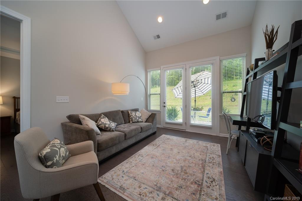 1002 Archibald Avenue Fort Mill, SC 29708 - Photo 15 of 26 a living room with furniture a flat screen tv and a large window