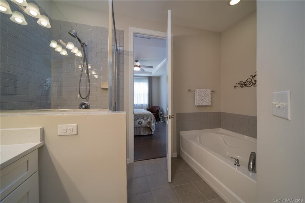 1002 Archibald Avenue Fort Mill, SC 29708 - Photo 19 of 26 a bathroom with a tub a sink and mirror