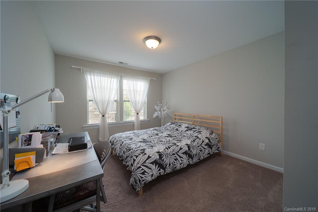 1002 Archibald Avenue Fort Mill, SC 29708 - Photo 23 of 26 a bedroom with a bed and large windows