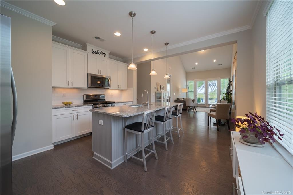 1002 Archibald Avenue Fort Mill, SC 29708 - Photo 9 of 26 a kitchen with stainless steel appliances granite countertop a stove top oven a sink a stove and a refrigerator