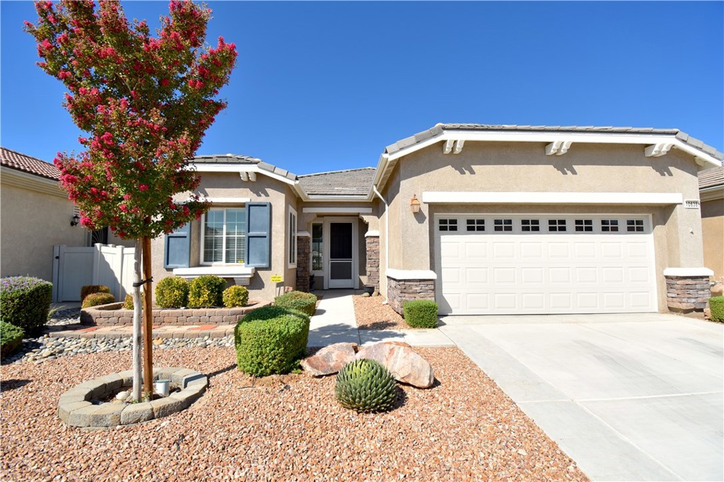 10638 Nobleton Road Apple Valley, CA 92308 - Photo 1 of 1 a front view of a house with garden