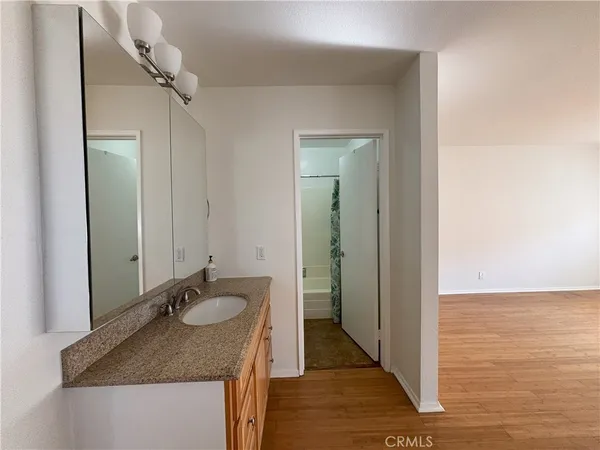 a bathroom with a granite countertop sink and a mirror