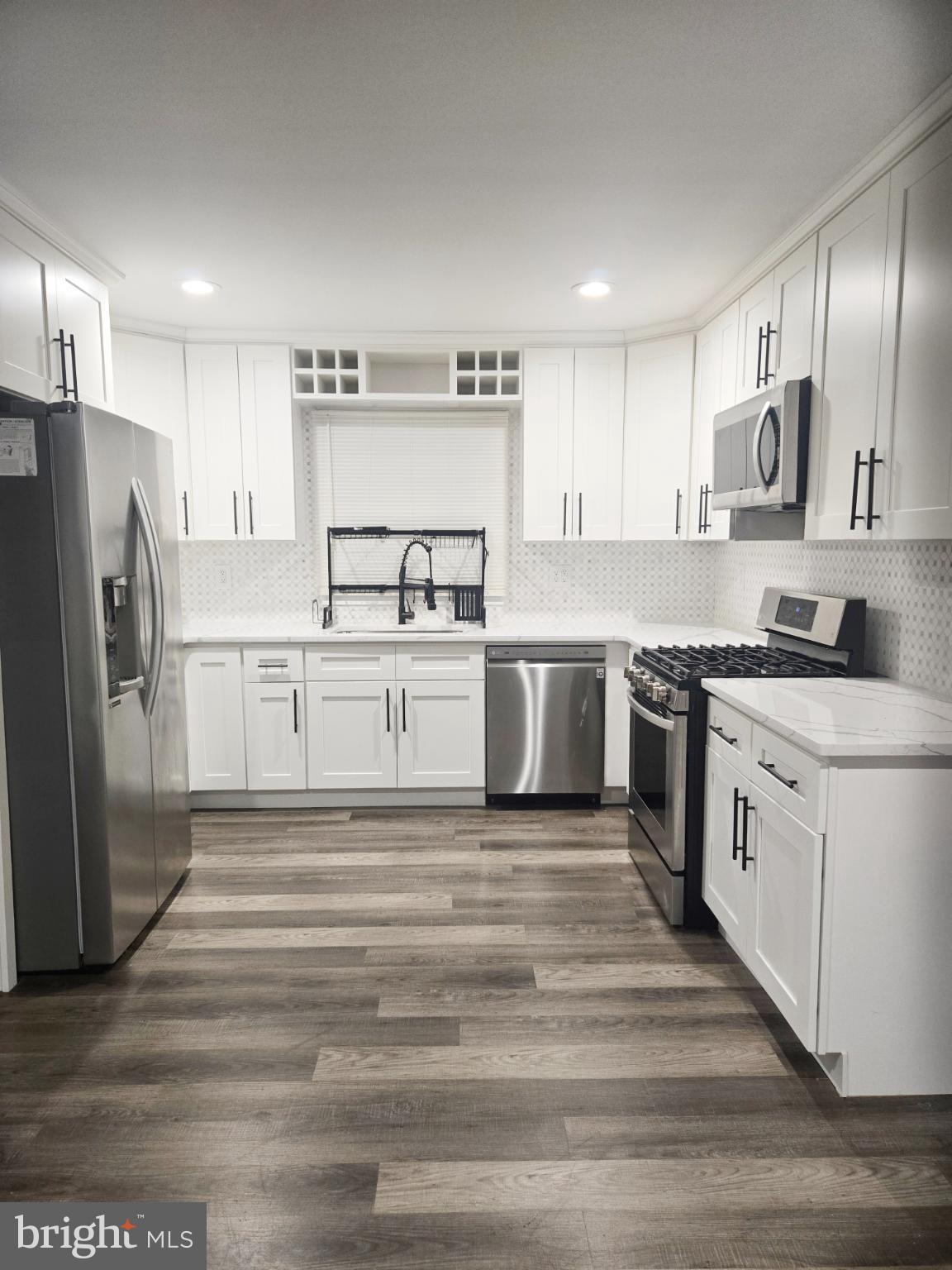 2 Middlebury Lane Willingboro, NJ 08046 - Photo 2 of 4 a kitchen with stainless steel appliances granite countertop a refrigerator sink and white cabinets