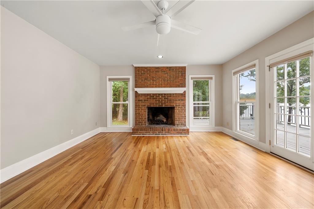 75 Spring Ridge Court Newnan, GA 30265 - Photo 14 of 75 a view of an empty room with wooden floor fireplace and a window
