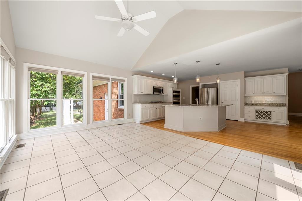 75 Spring Ridge Court Newnan, GA 30265 - Photo 24 of 75 a view of a electric appliances in kitchen and empty room with wooden floor