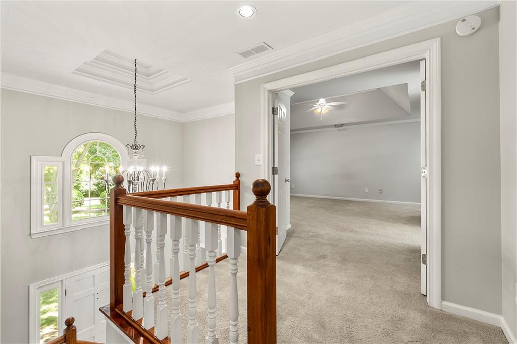 75 Spring Ridge Court Newnan, GA 30265 - Photo 38 of 75 a view of a hallway with windows and chandelier